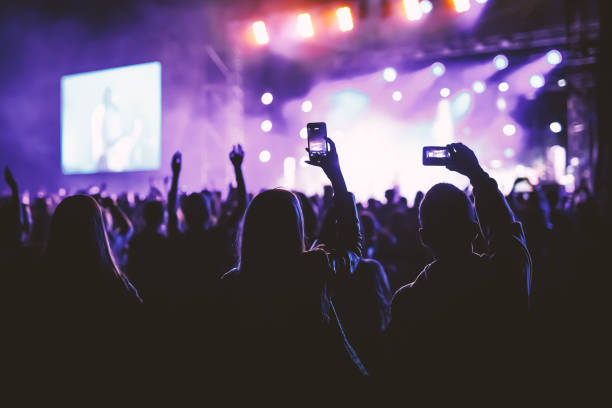 People holding their smart phones and photographing concert. People holding their smart phones and photographing concert audience photos stock pictures, royalty-free photos & images