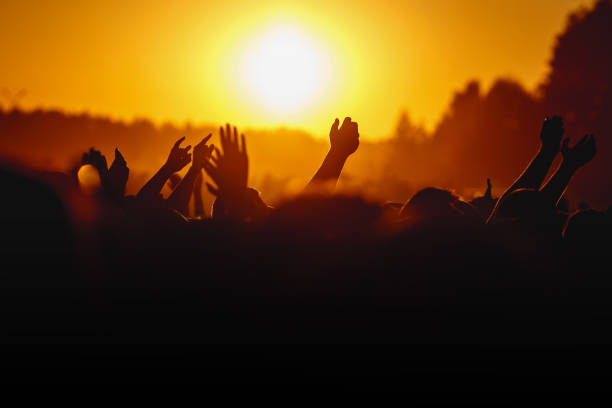 istock Raised hands of people on a big event. 1305092186