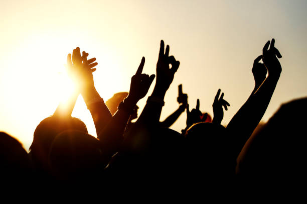 istock Raised hands of many people at a big mass event 1305092188