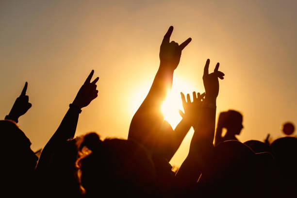istock Raised hands of many people at a big mass event 1305092192