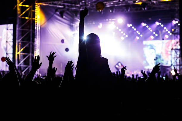 istock Girl silhouette on a big concert show. 1305092221