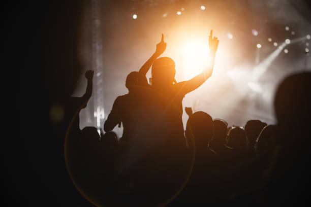 istock Raised hands in honor of a musical show on stage 1305092228