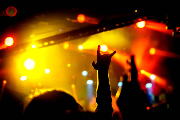 istock Raised hands of many people at a big public event 1305093228