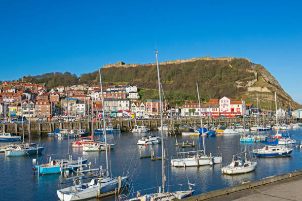 istock Harbor seafront town with castle on hill 1305094809