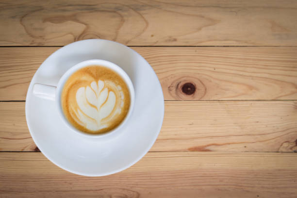 istock latte art coffee or cappuccino on wooden table background 1305096464