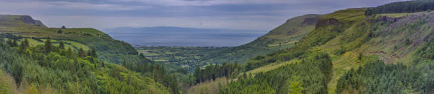 Glenariff known as Queens of the Glens and the biggest of the nine Glens of Antrim, County Antrim, Northern Ireland, UK panoramic view on Glenariff known as Queens of the Glens and the biggest of the nine Glens of Antrim, County Antrim, Northern Ireland, UK glenariff photos stock pictures, royalty-free photos & images