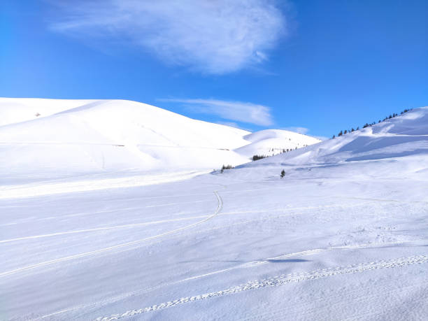 istock snowy hills and blue sky 1305098526