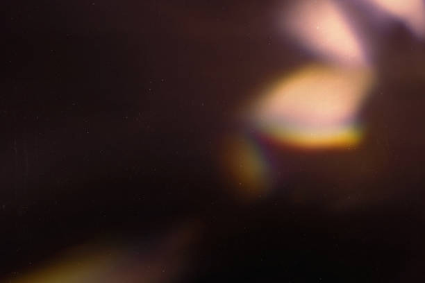 colorful warm rainbow light leaks on black background with dust texture