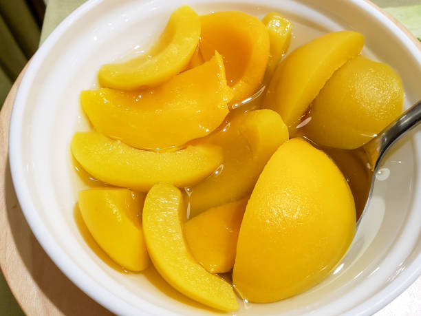 istock Peach in syrup in white bowl 1305099651