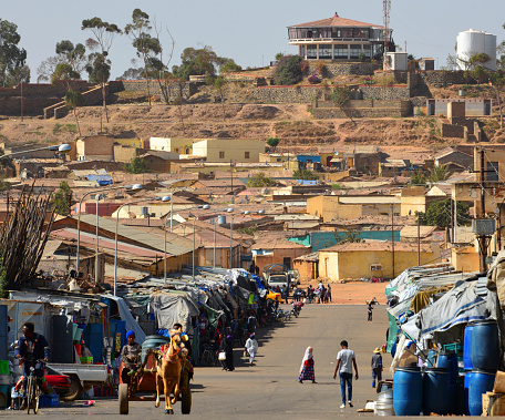 Asmara, Eritrea: hill top with water supply tanks and the Cherhi Recreation Center restaurant and Abashwley area, seen along Metera Street with horse-drawn cart.