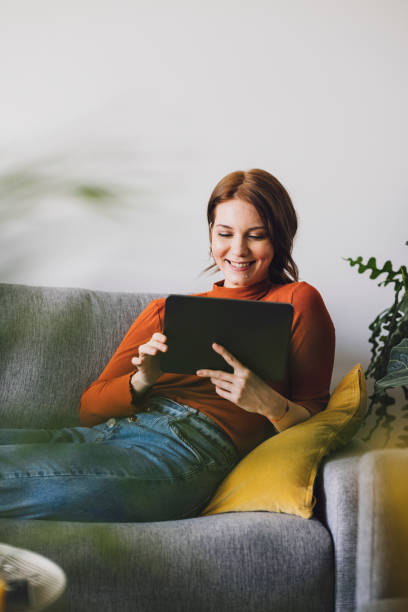 istock Women in Business: Smiling Young Businesswoman Using a Digital Tablet at Home 1305103325