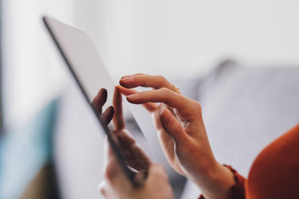 istock Women in Business: An Anonymous Young Businesswoman Using a Digital Tablet at Home 1305103338