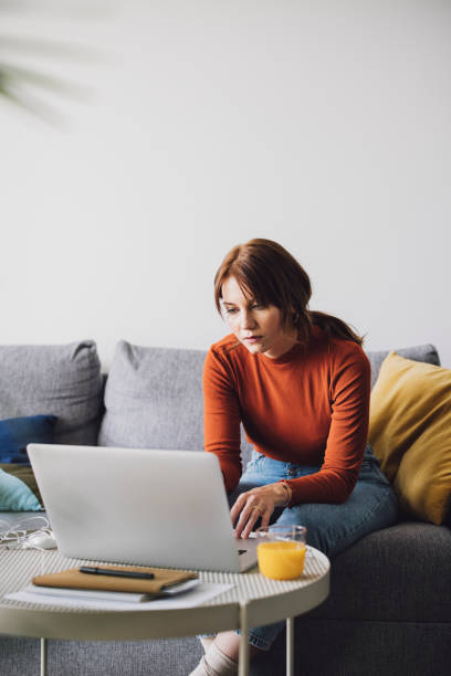 istock Women in Business: A Beautiful Young Businesswoman Using a Laptop While Working from Home 1305103352
