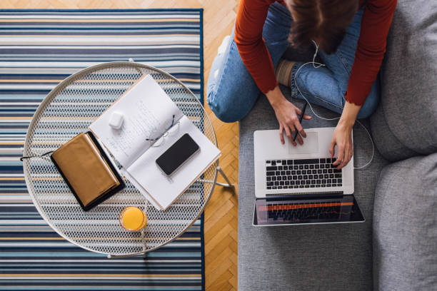 istock Women in Business: An Anonymous Businesswoman Using a Laptop while Working from Home 1305103387