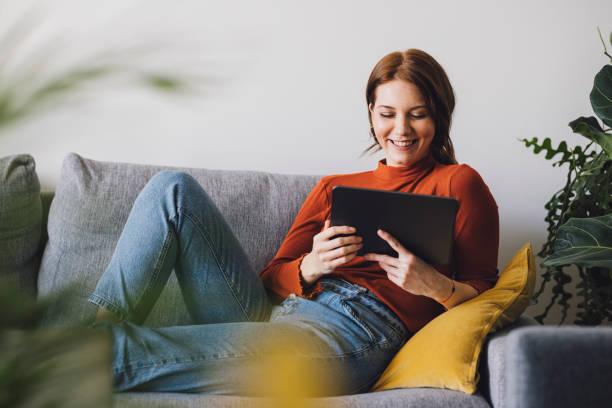 istock Women in Business: Smiling Young Businesswoman Using a Digital Tablet at Home 1305103410