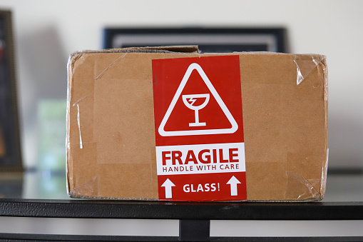 A cardboard box with a fragile sticker