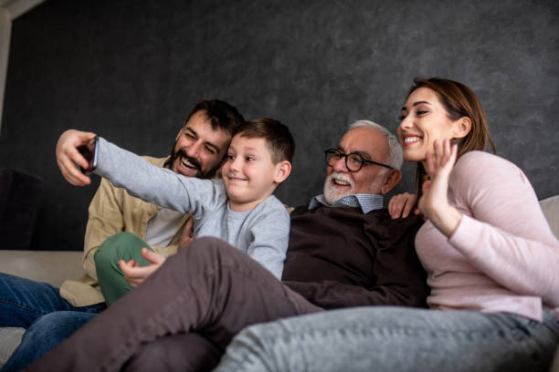 istock Little boy is taking selfie with his parents and his granddaddy. 1305105397