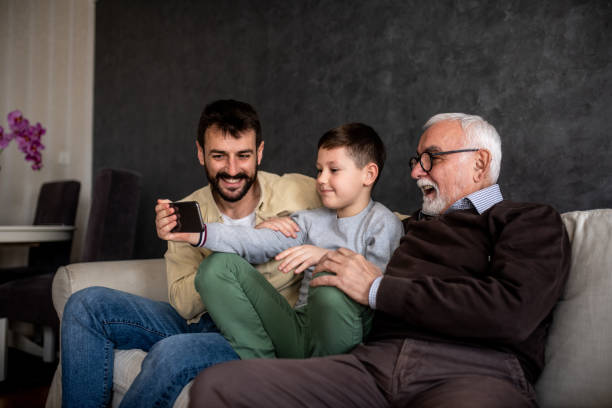 istock Young boy is taking selfie with his family. 1305106204