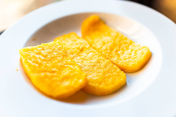 istock Polenta bright yellow orange corn cakes fried above view on white plate in restaurant appetizer golden color 1305106618
