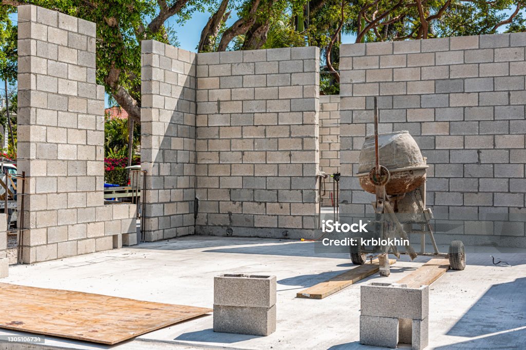 Portable mobile small cement mixer at construction building site for residential home house walls outdoors in Florida keys city Construction Site Stock Photo