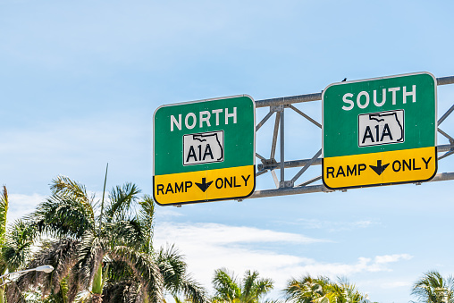 Florida state road highway street A1A to North or South ramp only direction signs in Miami Dade county with palm trees and blue sky