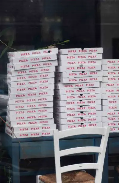 Pizza boxes in a window