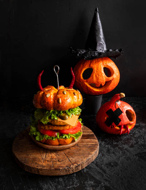 istock Funny pumpkin veggie burger . Halloween 1305108169