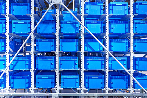 Large group of blue crate and shelf at distribution warehouse.
