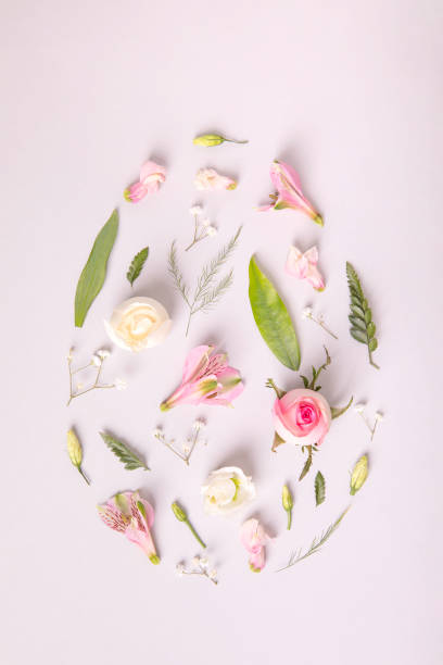 istock Egg shape from spring nice colourful flowers and leaves. Flat lay easter concept. 1305110208