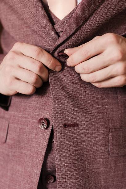 istock the man fastens the buttons on his jacket 1305111504