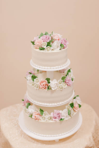 istock big white wedding cake with flowers on the table 1305111505