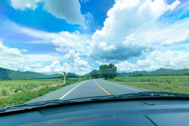 Driving car on the mountain road,Going forward down the highway ,Ahead Only Sign,Asphalt,Backgrounds,Car,Car Interior,Color Image,Country Road,Day,Direction,Dividing Line - Road Marking,Driving,Forest,Front View,Highway,Hill,Hope - Concept,Horizontal,In Front Of,