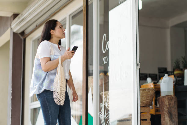istock Woman using smartphone to get direction to supermarket 1305115041