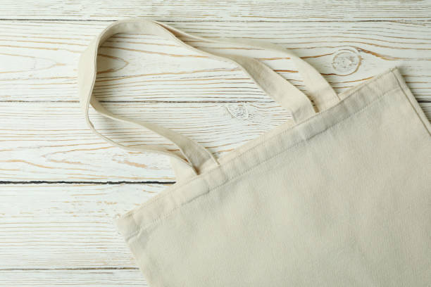 istock Eco bag on wooden background, space for text 1305115123