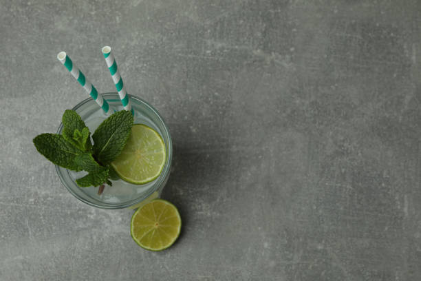 istock Glass of mojito cocktail on gray table 1305116631