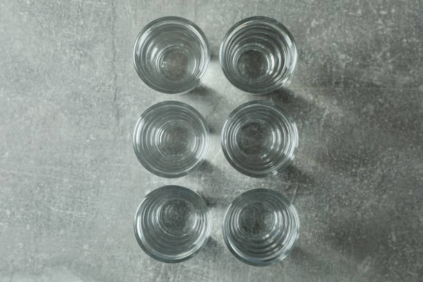 istock Shots with vodka on gray background, top view 1305117397