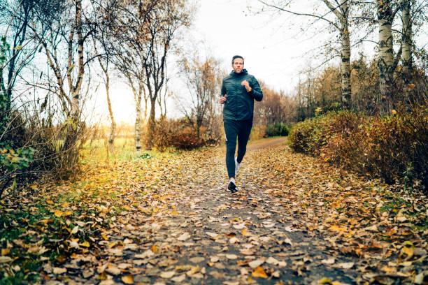 istock Man running in the park on a  autumn day 1305118050