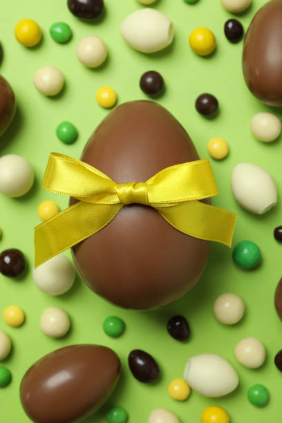 istock Easter chocolate eggs and candies on green background 1305118538