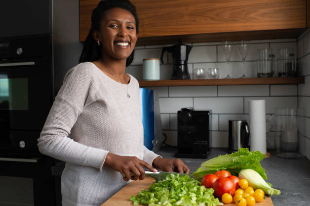 istock Woman cutting salad leaves. 1305118752