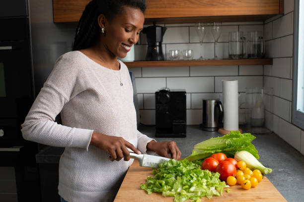 istock Woman cutting salad leaves. 1305118795