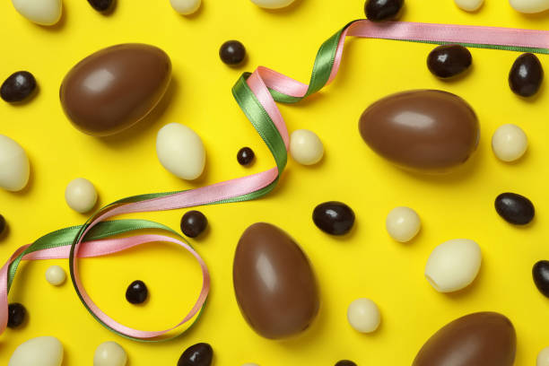 istock Easter chocolate eggs and candies on yellow background 1305118894