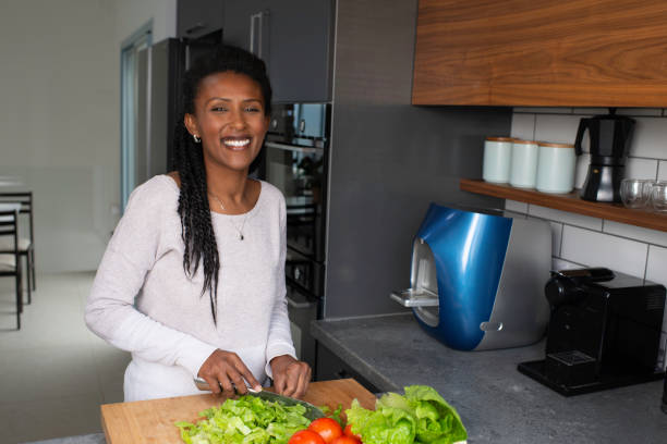istock Woman cutting salad leaves. 1305119215