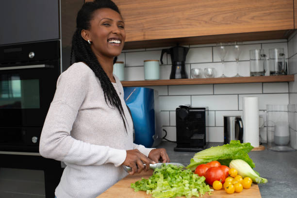 istock Woman cutting salad leaves. 1305119748
