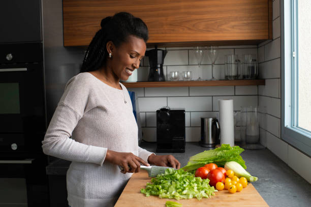 istock Woman cutting salad leaves. 1305120024