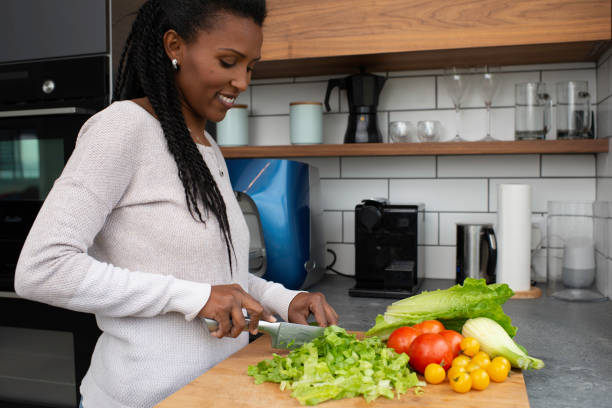 istock Woman cutting salad leaves. 1305120086