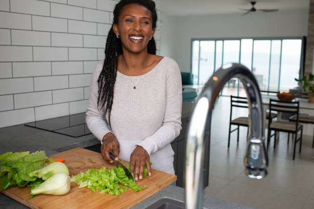 istock Woman cutting salad leaves. 1305120355