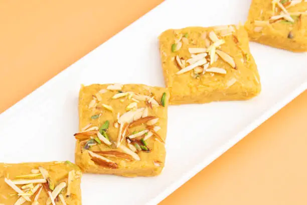 Photo of Indian Mithai Lachedar Patisa With Various Names Soan Papdi San Papdi Sohan Papdi Sukhdi Or Sonpapdi Son Roll Is Made Of Gram Wheat Flour Besan Kaju Pista Badam Dry Fruits Jaggery Fried In Desi Ghee