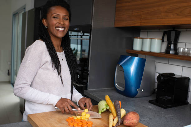 istock Woman slicing carrots at the kitchen counter. 1305122101