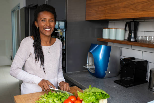 istock Woman cutting salad leaves. 1305122566