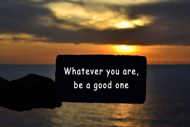 istock Whatever you are be a good one text on hand holding torn paper with blurred background of sunset at the beach of Tanjung Aru Beach, Kota Kinabalu, Borneo,Sabah, Malaysia 1305123073